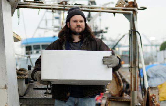 Man carrying supplies on a fishing boat