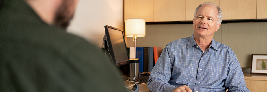 Man representing a healthcare provider speaking to a sales representative