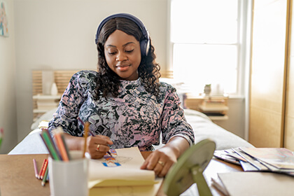 LYBALVI.com provides you with tools and resources to help support your patients Woman drawing a picture and listening to music