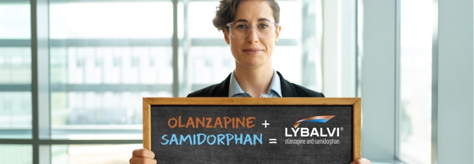 Woman smiling and holding a sign that shows the components of LYBALVI® (olanzapine and samidorphan)